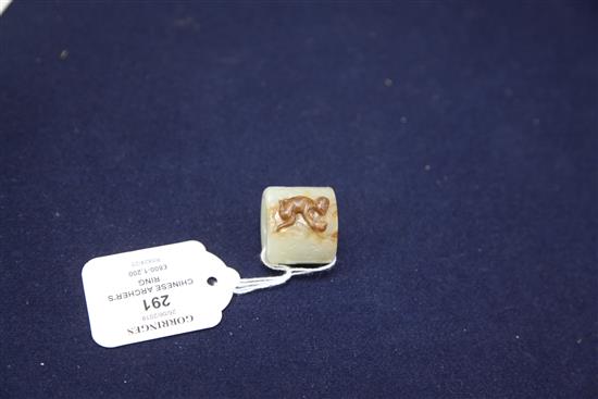 A good Chinese pale celadon and russet jade archers ring, 18th/19th century, height 2.5cm, diameter 2.8cm